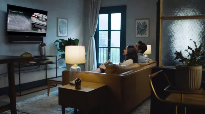 Couple viewing the X1 Auto Showroom on TV