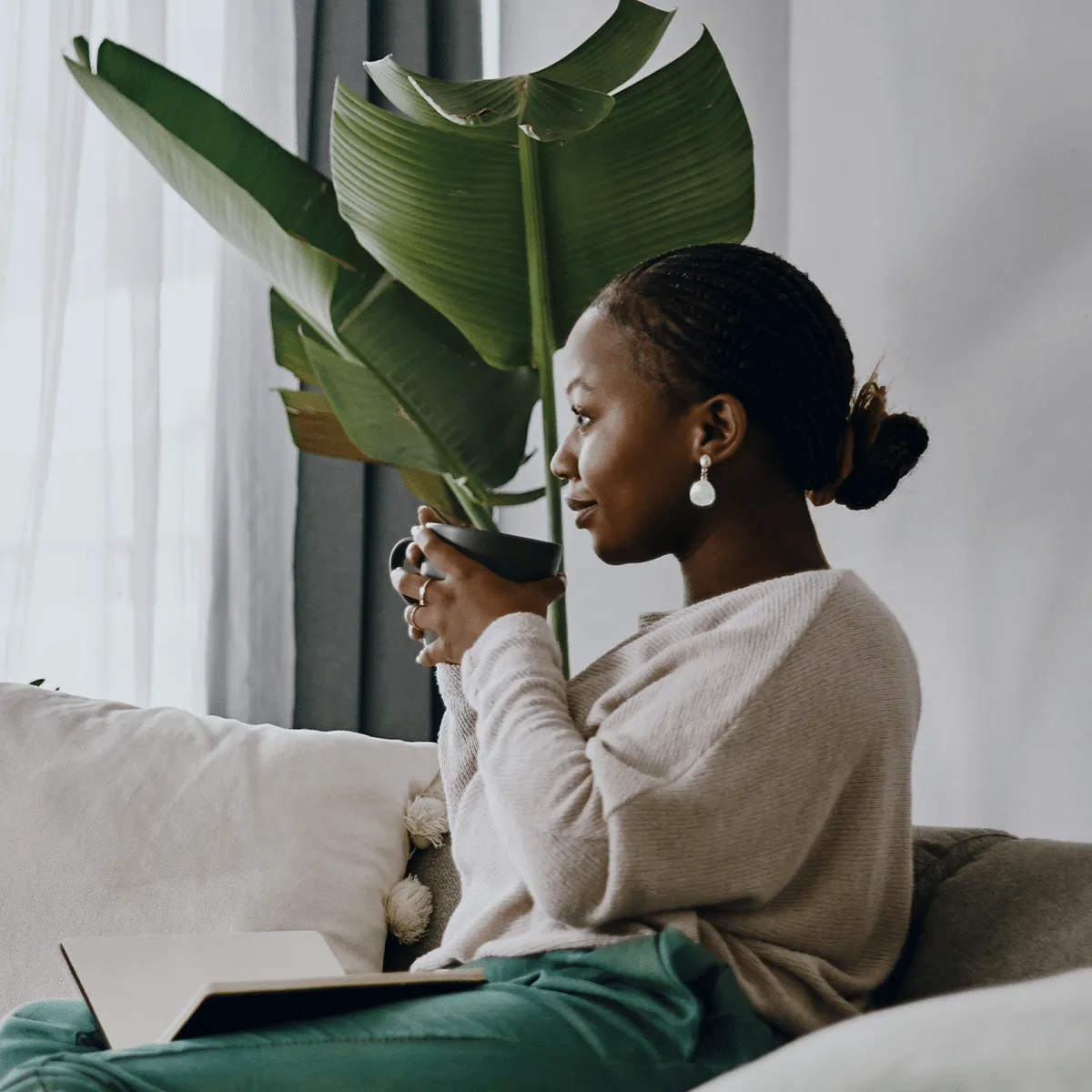 Woman sitting on the couch watching TV