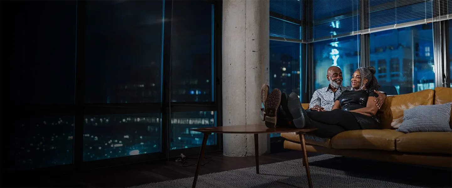 Mature couple sitting on the couch watching TV