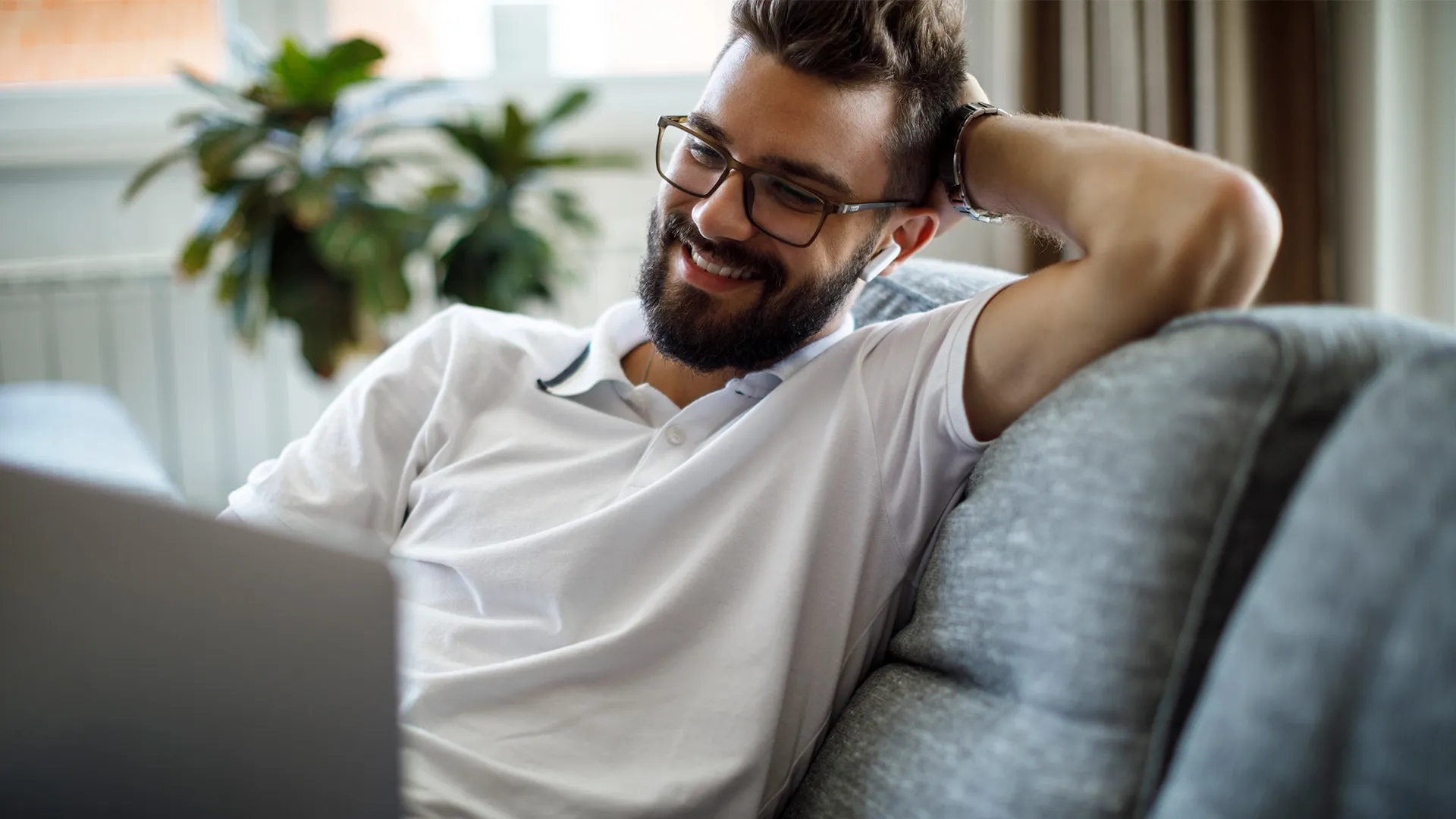 Man smiling and sitting on the couch